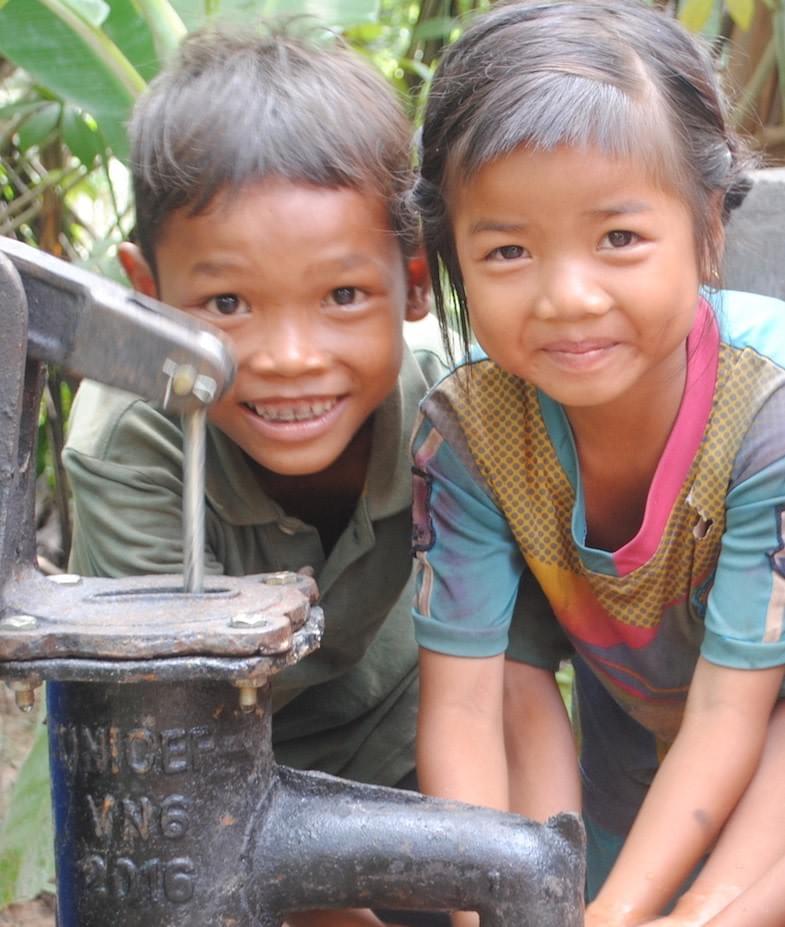 Cambodian children smiling appreciatively after their family received Well #65, donated by MTRF Cambodian children smiling appreciatively after their family received Well #65, donated by MTRF